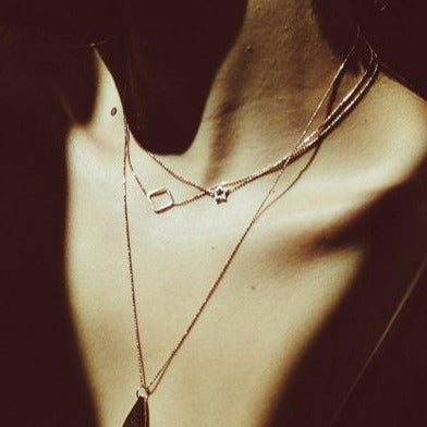 14k gold star necklace on model with PESH