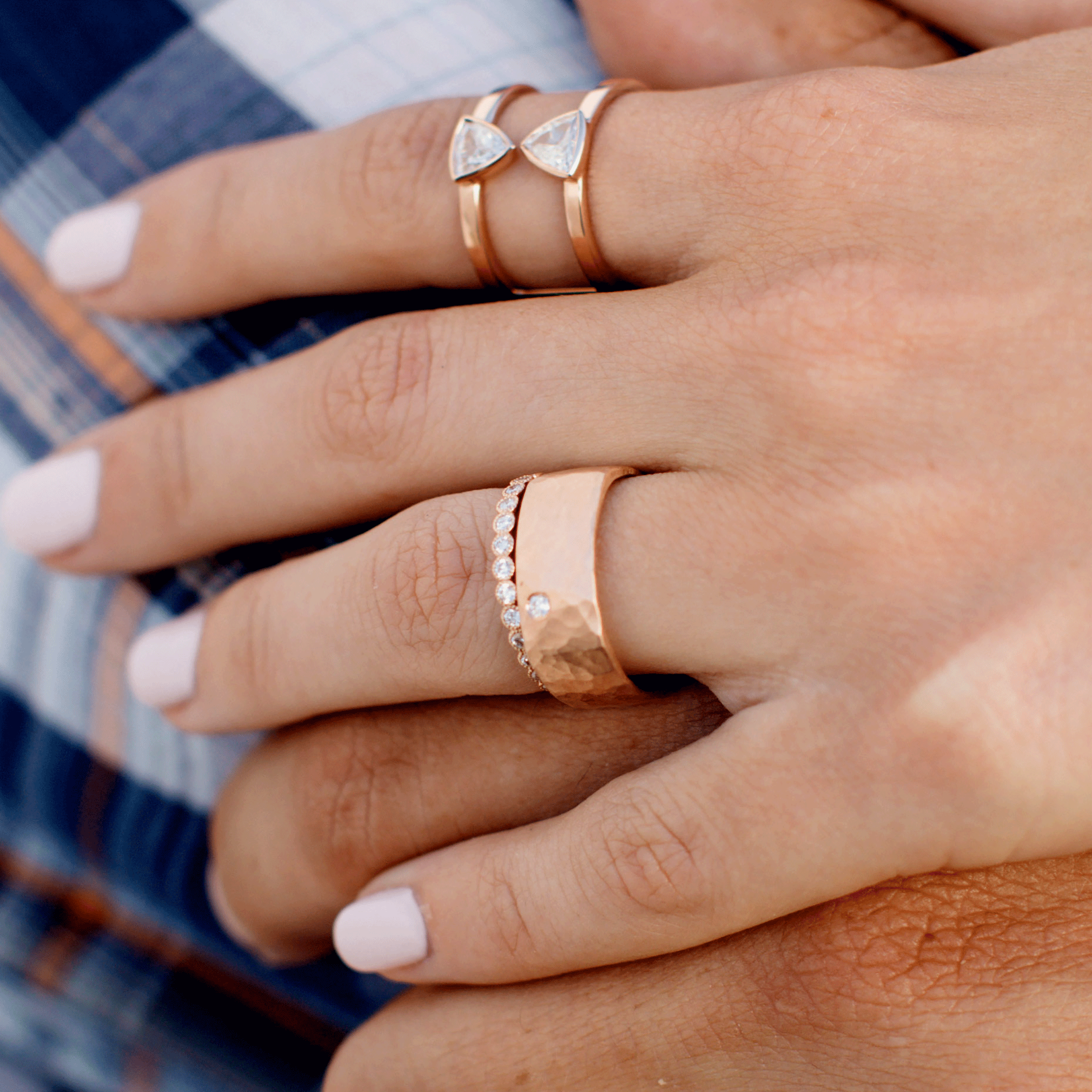 14k gold REFE square hammered band with single diamond on model hand with RAZZ diamond band