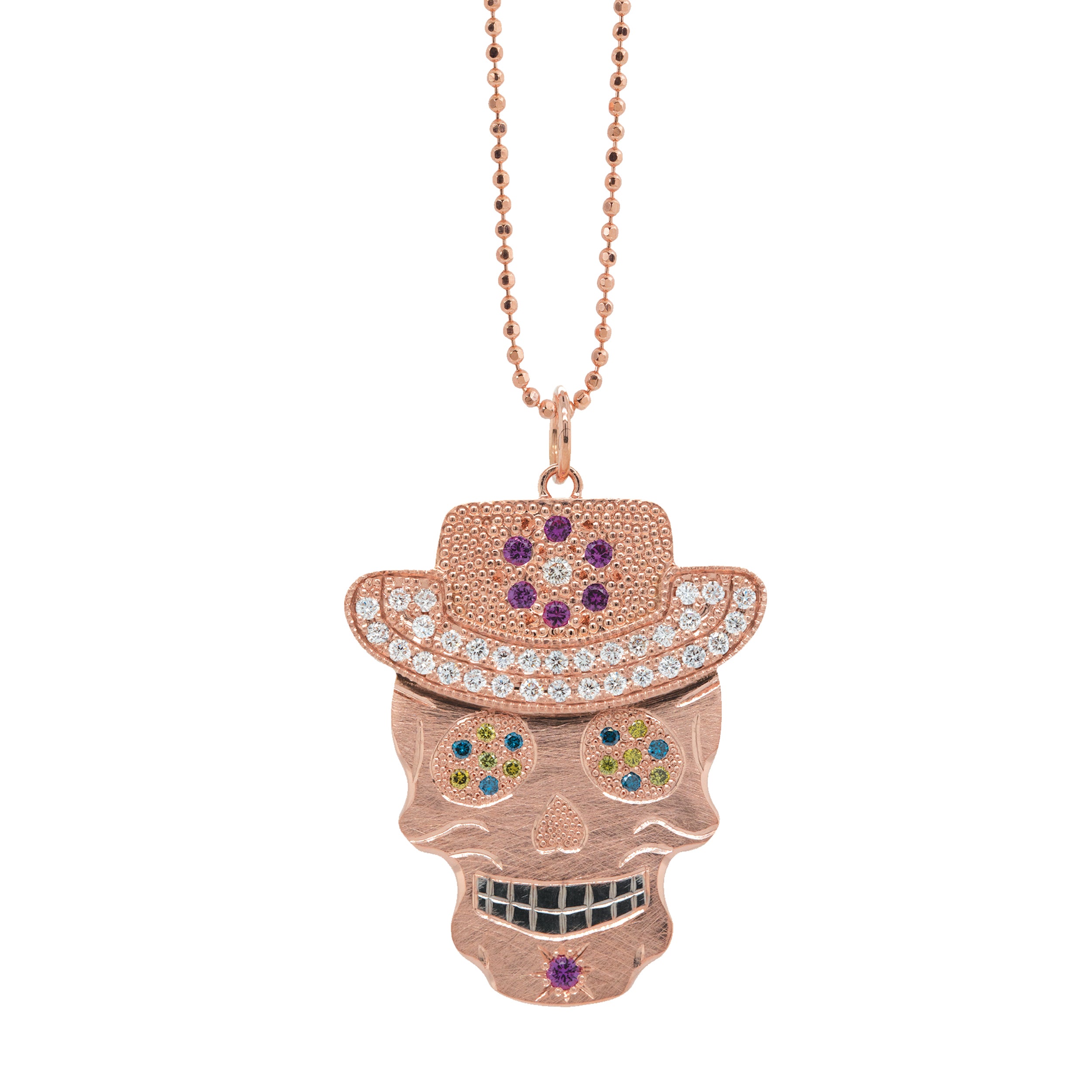 Vibrant colorful Julez Bryant original Ghostrider Collection Vaquero gemstone encrusted sugar skull wearing cowboy hat rose gold white rhodium darkened teeth. Extra large pendant in 14k solid rose gold mixed diamond sapphires and Tzavorite. Fine detail engraving highlights features. Hat of flower clustered jewels in mixed colors. Eyes with green Tzavorite and blue sapphire pave set gemstone eyes. Diamond encrusted brim Large pink sapphire and diamondFlower pave set detail on hat.  Shown on 2.0mm ball chain.