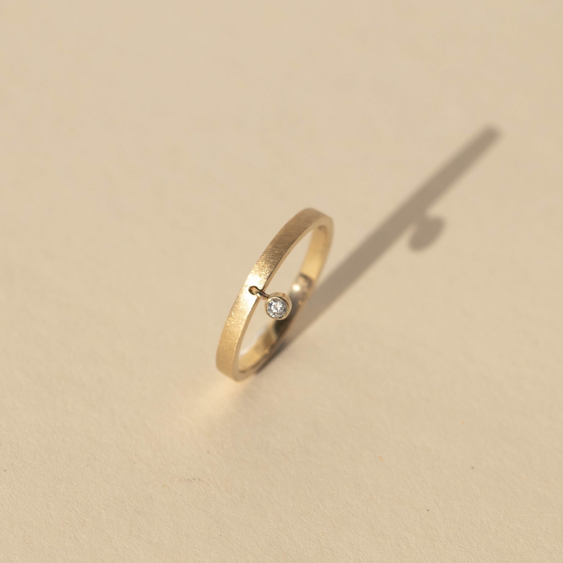 14k gold GELT stacker ring with diamond in studio