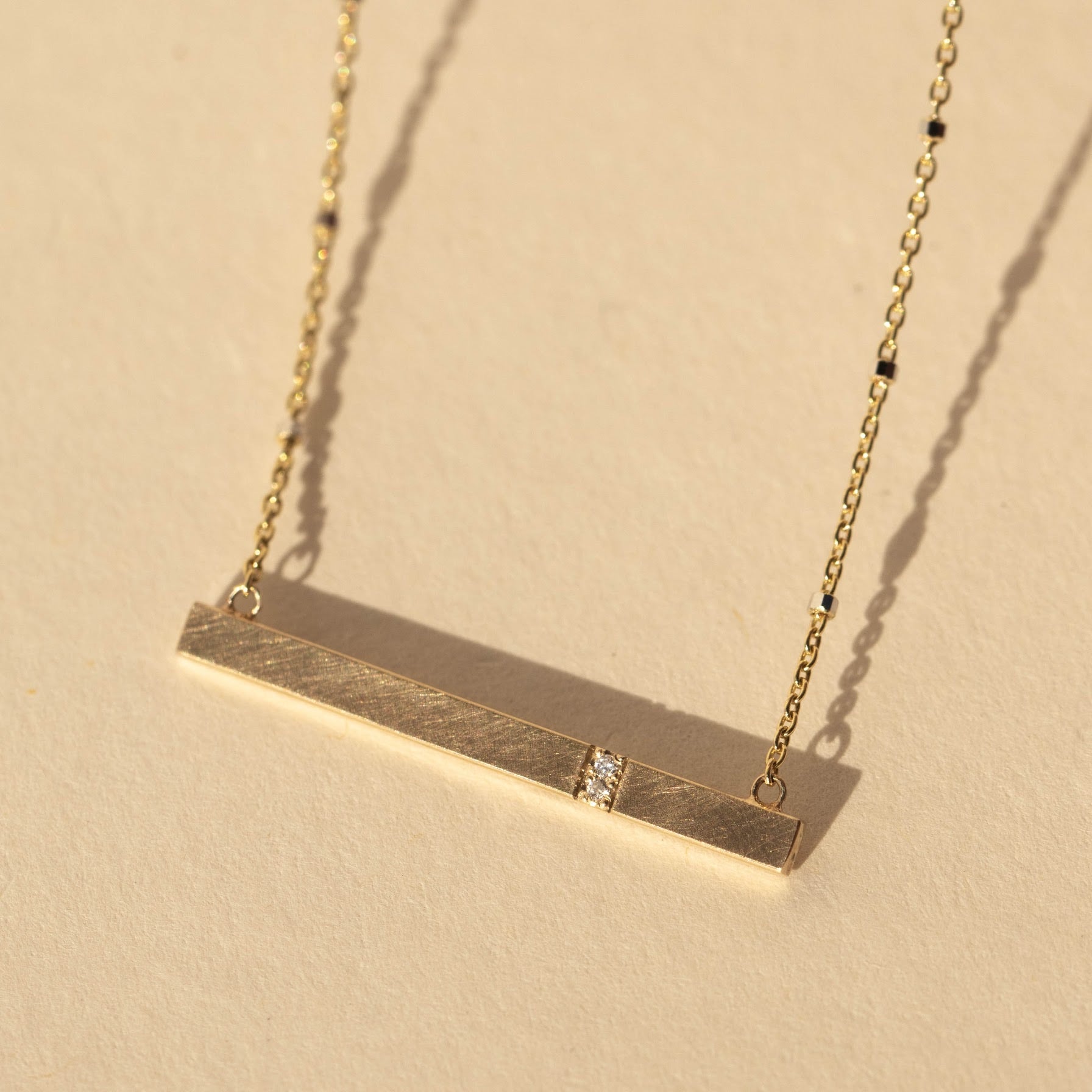14k gold GNAR necklace in studio