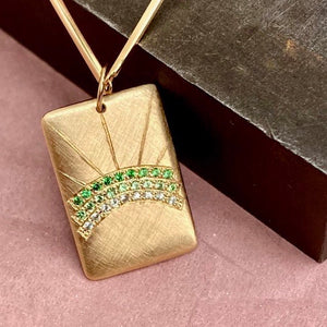 14k gold CAYY pendant with diamond and green carnet rainbow in studio