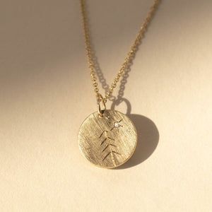 14k gold GREE etched tree charm in studio